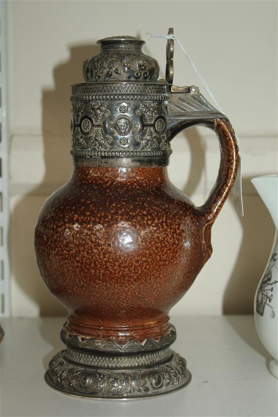 An Elizabethan style tiger ware jug, George V silver mounts, 9.75in.